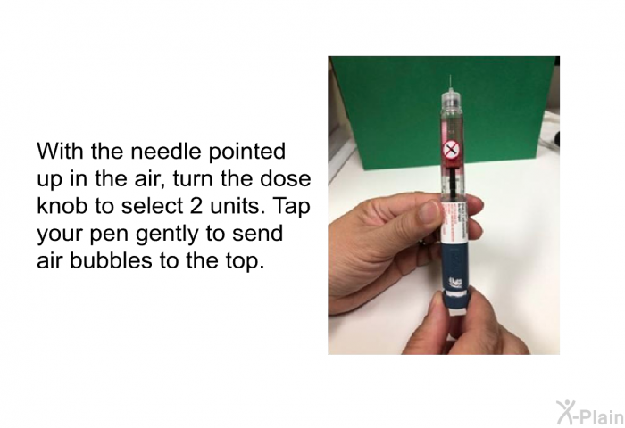 With the needle pointed up in the air, turn the dose knob to select 2 units. Tap your pen gently to send air bubbles to the top.
