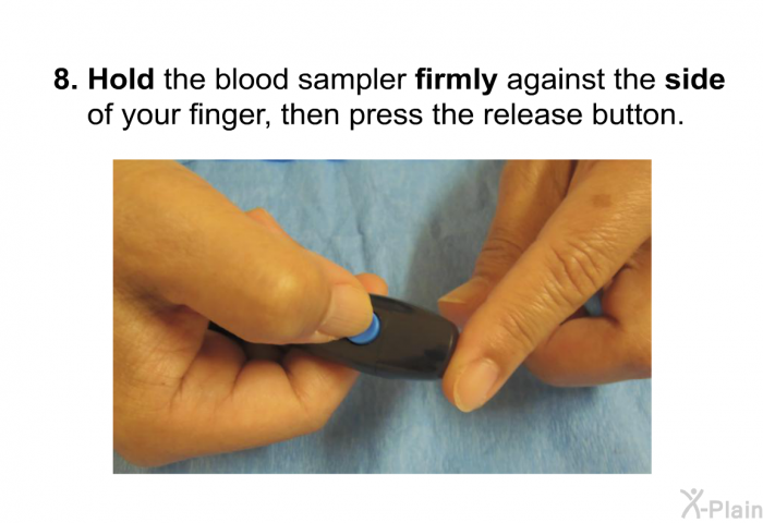 Hold the blood sampler <B>firmly</B> against the <B>side</B> of your finger, then press the release button.