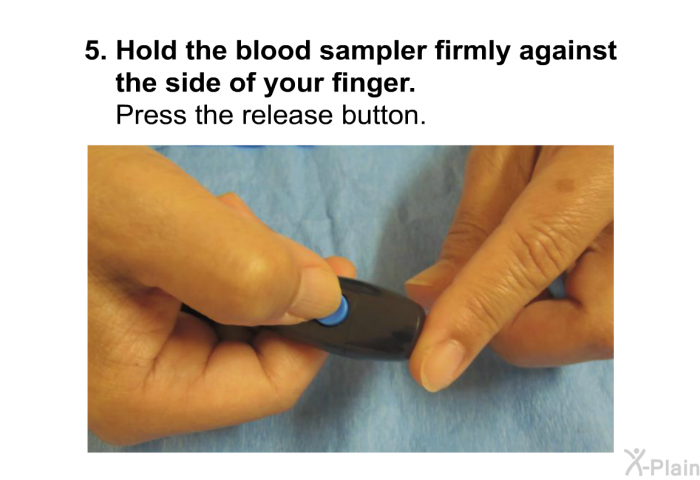 Hold the blood sampler firmly against the side of your finger. Press the release button.